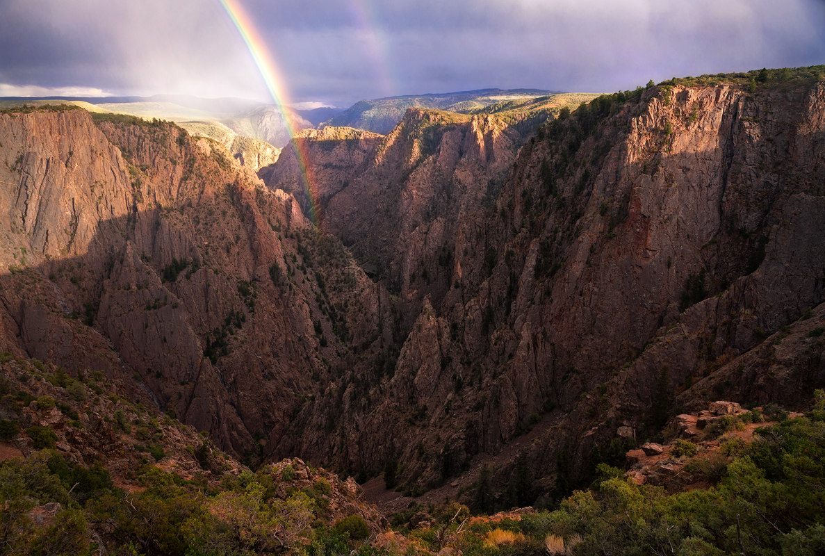 A late season monsoon storm produced a spectacular rainbow over the heart of the Black Canyon gorge just before sunset.