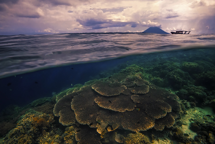 A view below the surface as a tropical squall blows across the pristine waters near Bunaken island.