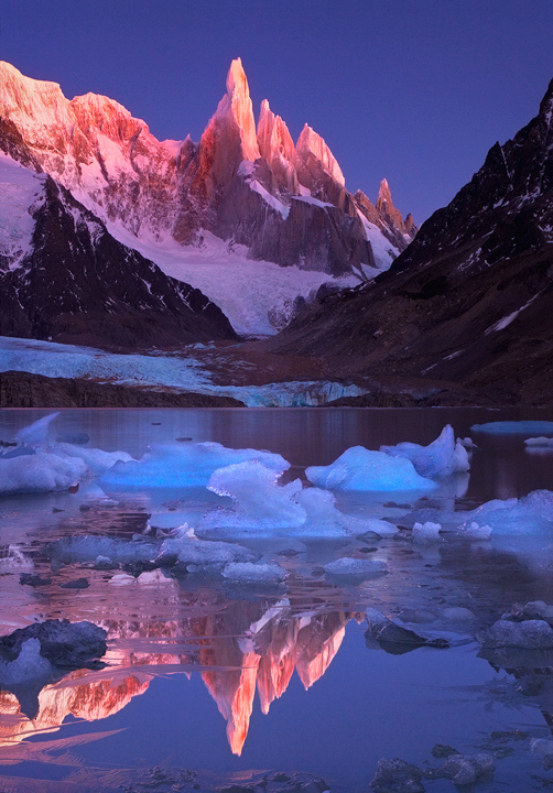 Cerro Torre, one of the most spectacular mountains on earth, catches the first pink rays of sunrise on a clear and cold morning...
