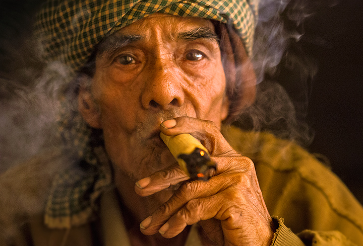 Satisfaction Traditional Cherub smoking is still common in the rural areas of Burma.