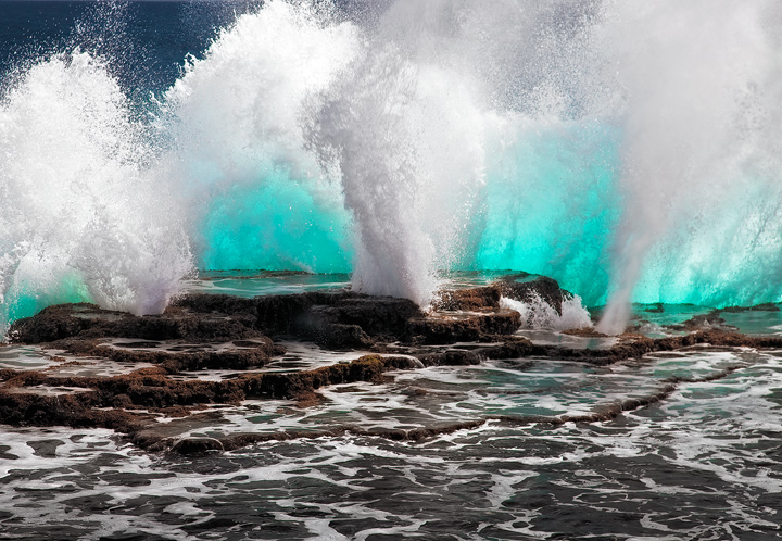 Explosion in Blue An open ocean swell crashes into the rugged volcanic coastline of Tongetapu Island, Tonga.