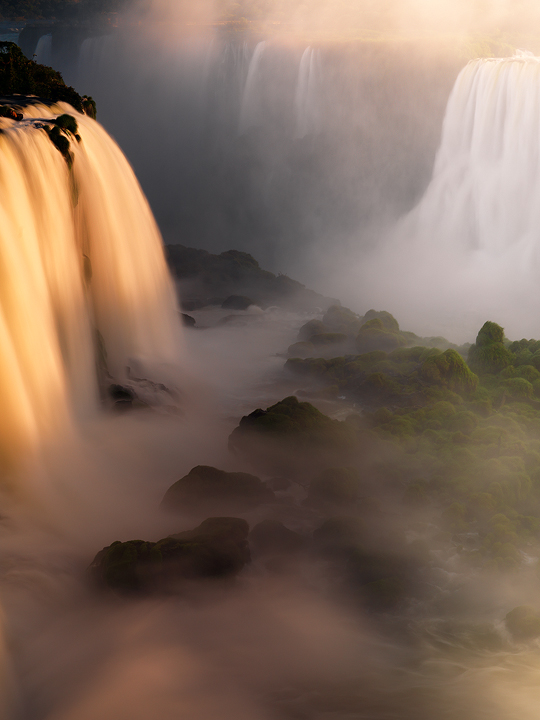 The swirling waters of the Iguazu River tumble into the sunset mist of the rainforest. I took this a day after my other version...