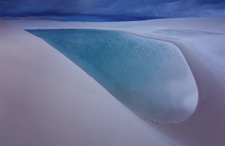 A stormy twilight illuminates the surreal landscape of the Lencois Maranhenses.&nbsp; This was taken half way through my barefoot...