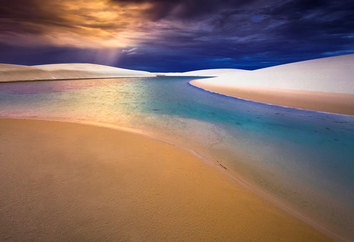 The dunes of Lencois Maranhenses are like nature's canvas- the golden white sands reflect the full spectrum of sunset colors...