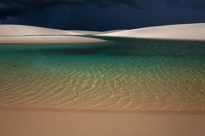 Preparing to get drenched by a powerful thunderstorm spreading over the empty dunes.