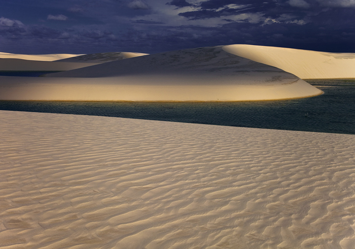 Beautiful light accents the sweep of dunes.  The play of equatorial light and shadow filtering through the late afternoon clouds...