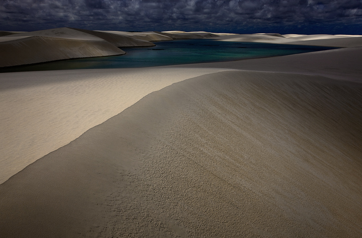 Contours of light and shadow sweep and dance across the remote lakes and dunes of Lencois Maranhenses, one of the most surreal...