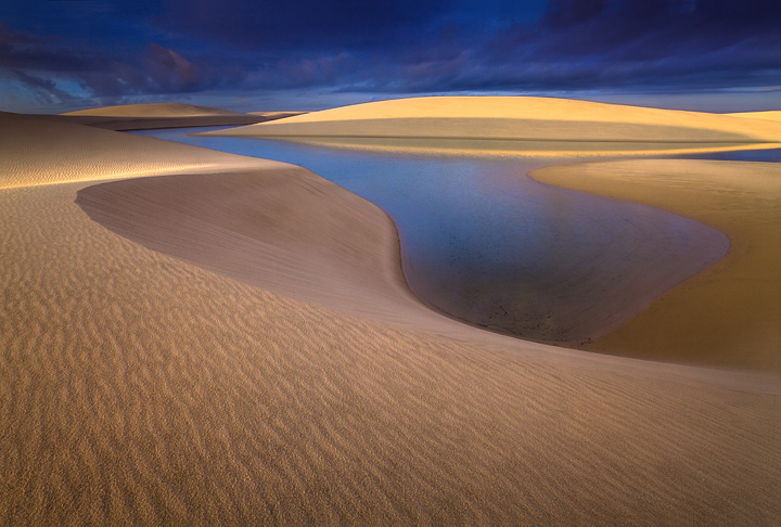 A warm&nbsp;tropical sunrise illuminates the lakes and&nbsp;dunes of the Lencois Maranhenses.&nbsp; I was happy to see the sun...