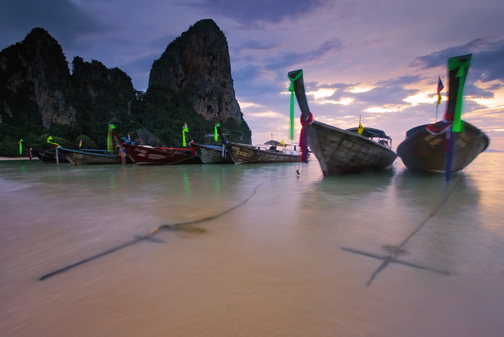 Longtail boats rest in a&nbsp;quiet anchorage away from the tropical monsoon winds&nbsp;of South Thailand.&nbsp;