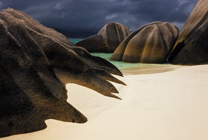 Late afternoon light shines on the sculpted boulders of Anse Source D'Argent beach, Seychelles.